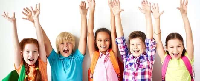 Kids raising their hands for school