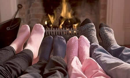Feet Warming By Fireplace