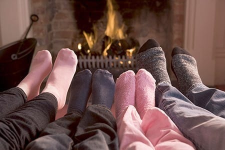 Feet Warming By Fireplace