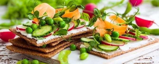 Vegetables and cheese spread on crackers