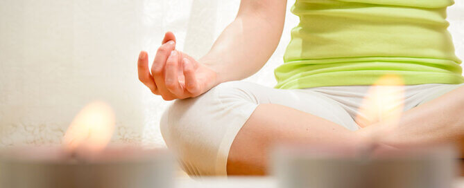 Woman Meditating with Candles