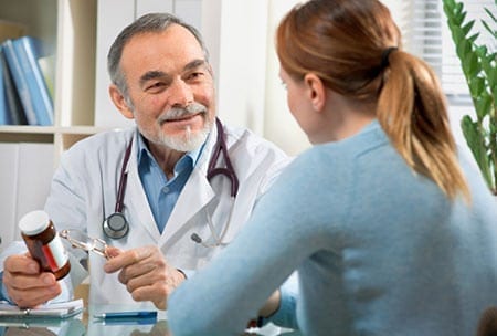 Old Doctor Talking with Patient