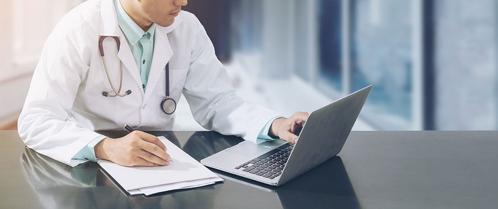 Doctor looking at laptop screen