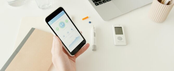 A person checking blood sugar with a phone