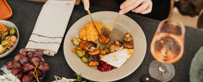 A person eating roasted vegetables
