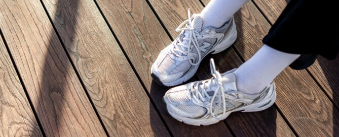 A person’s feet with socks and sneakers