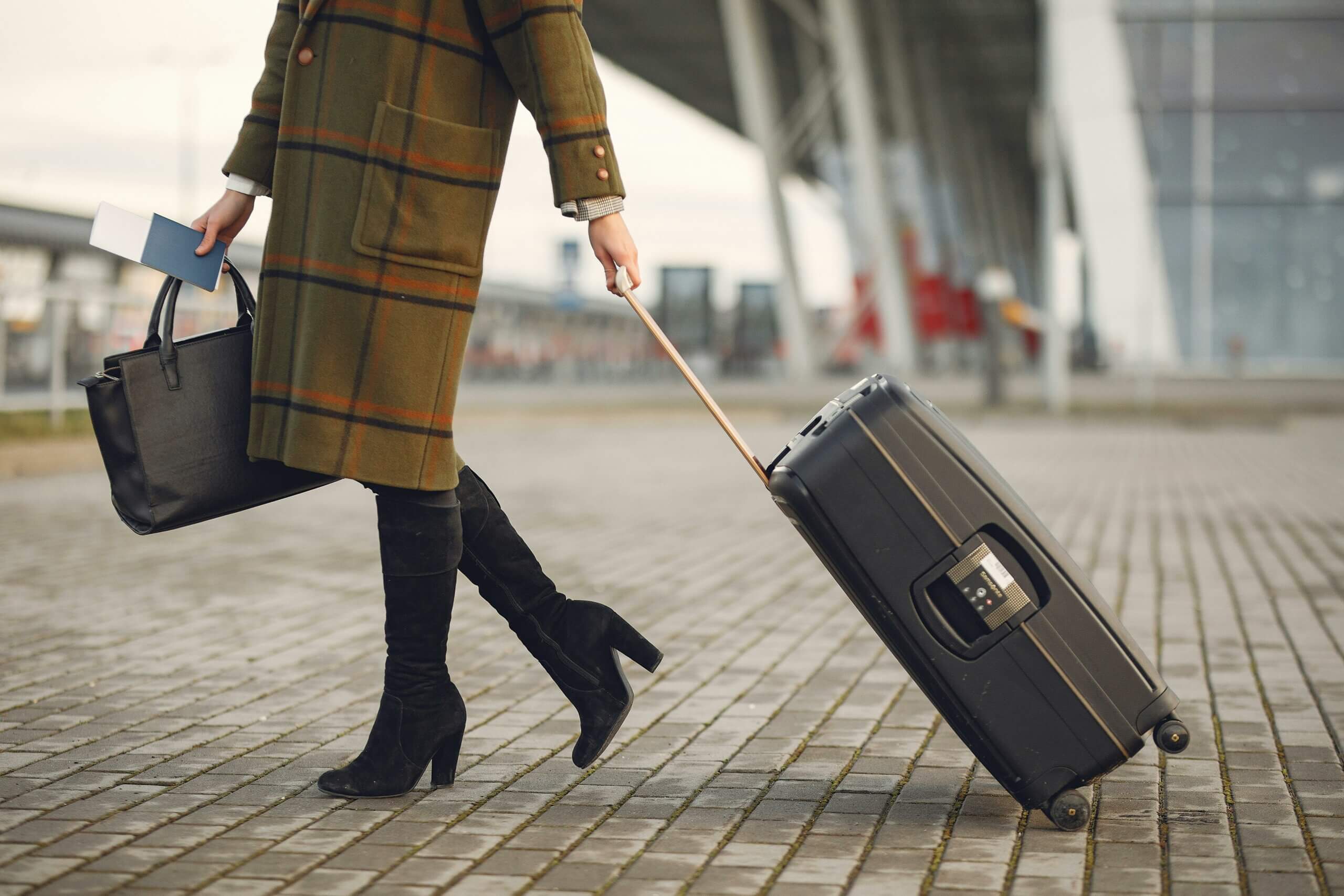 A woman with luggage at an airport