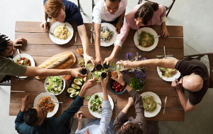 Group of friends toasting drinks and enjoying diabetes-friendly food
