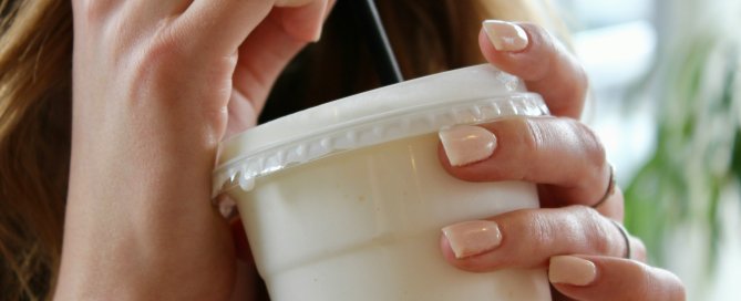 A woman drinking a meal replacement shake
