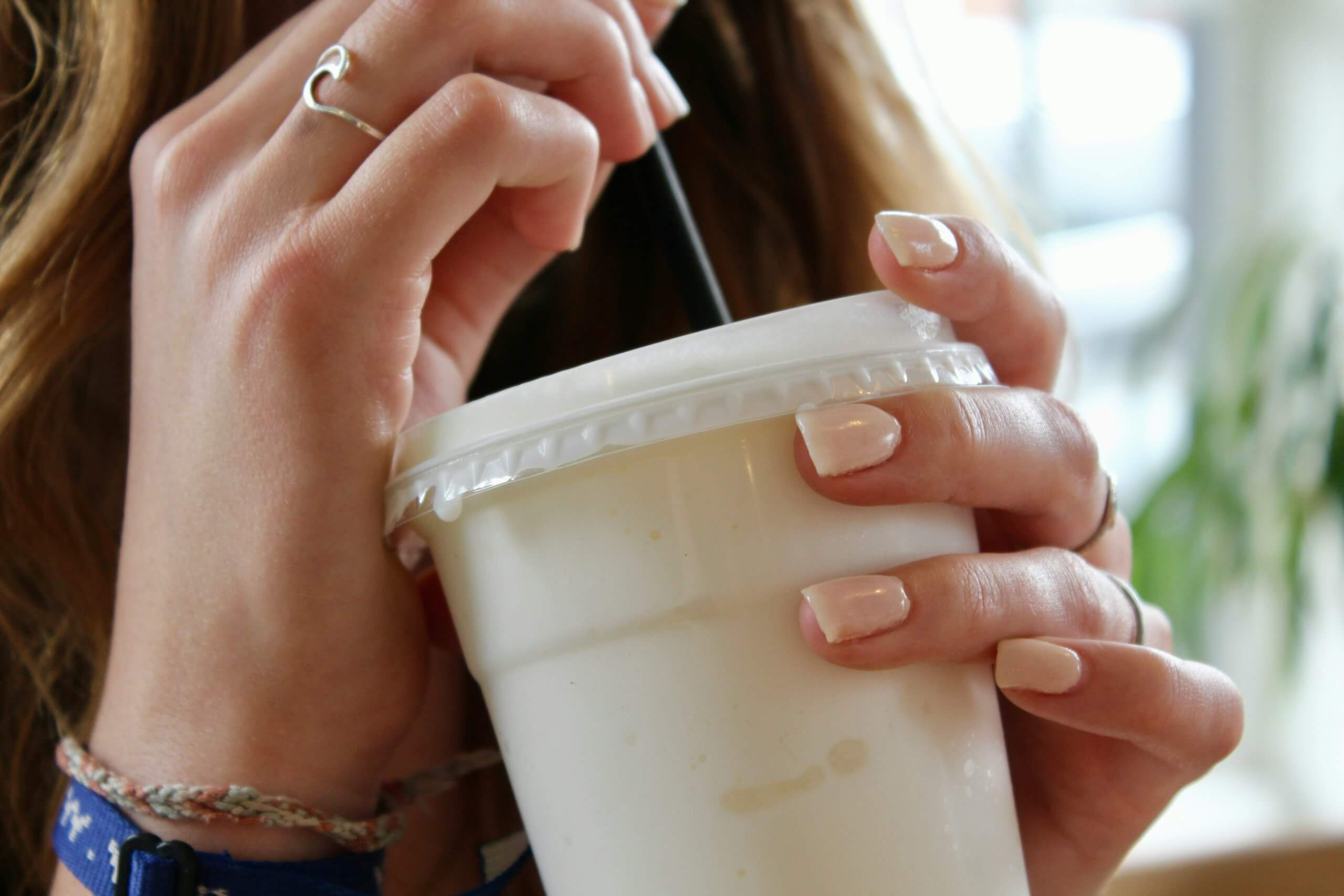 A woman drinking a meal replacement shake