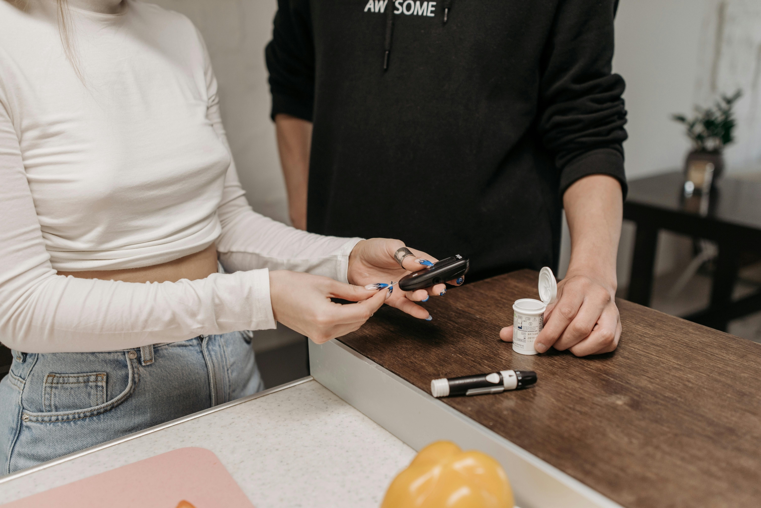 Teenager testing blood sugar