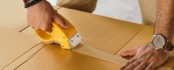 a person packaging up supplies to mail